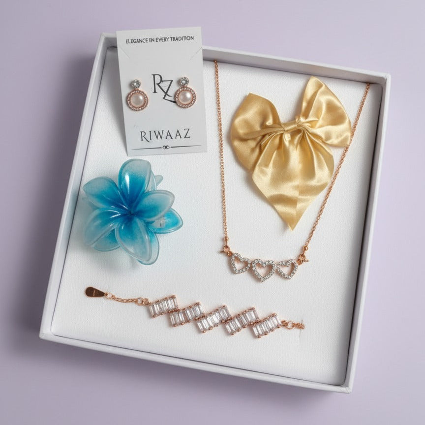 Jewelry set including necklace, earrings, and flower in a RIWAAZ box on a light purple background